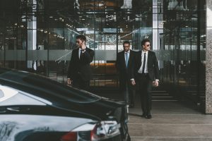 businessman-and-two-bodyguards-walking-to-auto.jpg