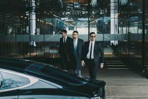 businessman-and-two-bodyguards-walking-to-car.jpg