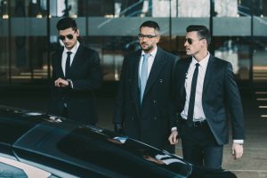 two-bodyguards-going-with-businessman-to-black-car.jpg
